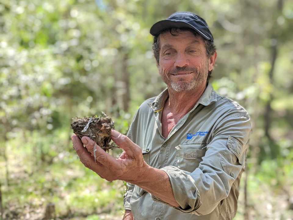 Field researcher holding a soil sample in bushland